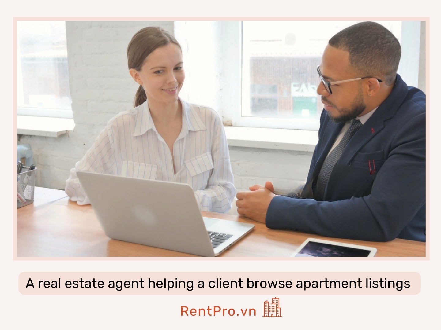 A-real-estate-agent-helping-a-client-browse-apartment-listings