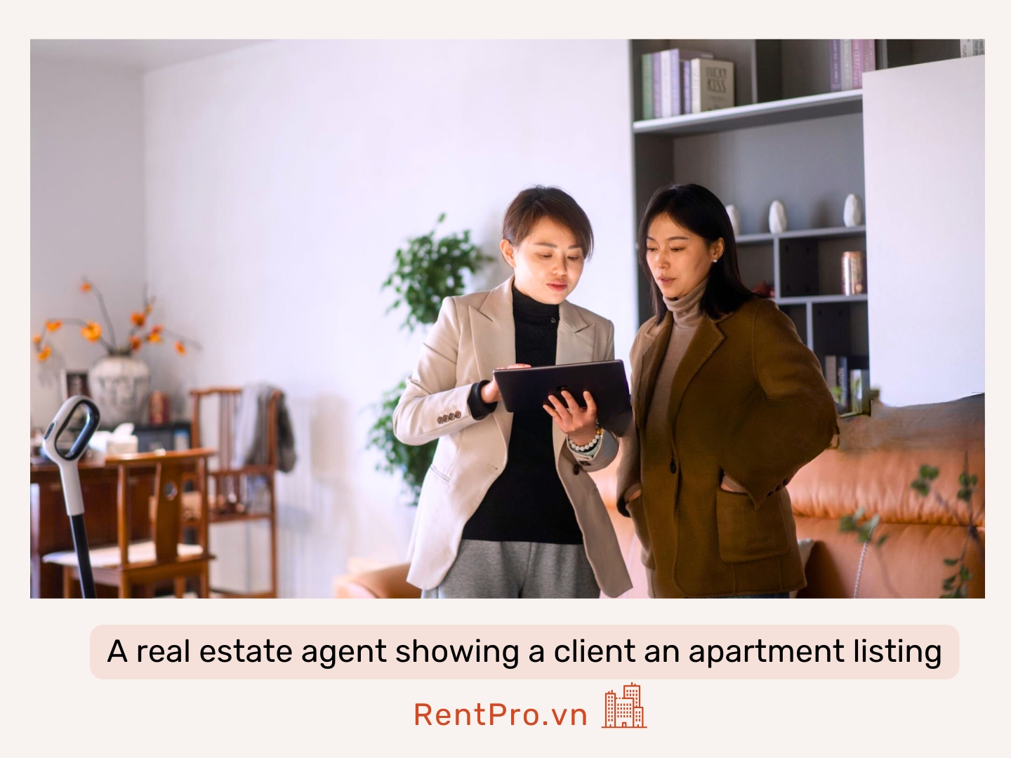 A-real-estate-agent-showing-a-client-an-apartment-listing